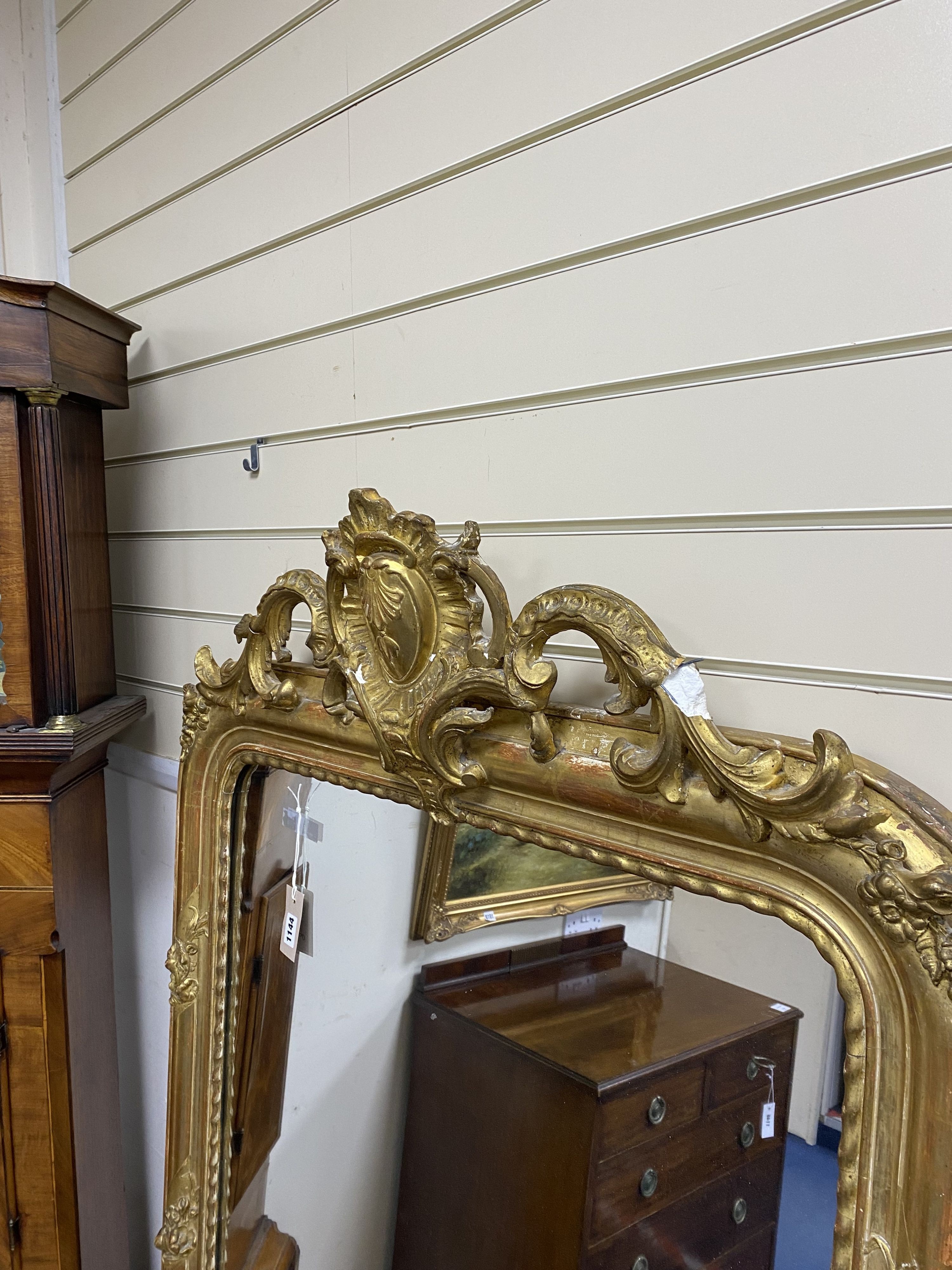 A 19th century French overmantel mirror, giltwood and gesso with channelled frame and scroll with cabochon crest detail, width 98cm, height 164cm